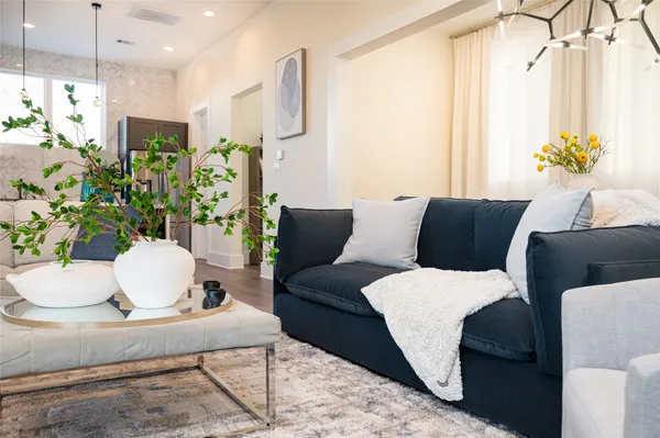 a living room with furniture and a chandelier