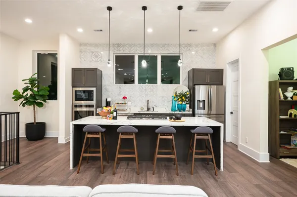 a kitchen with a table chairs refrigerator and sink
