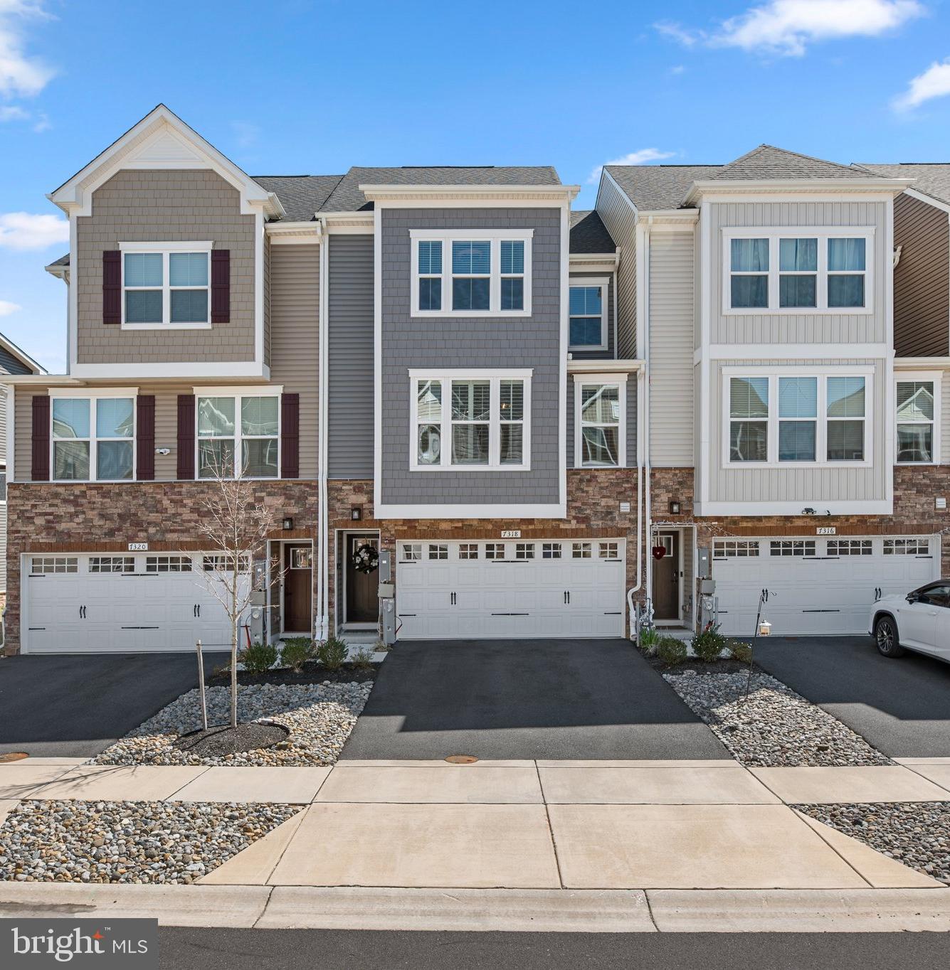 a front view of a residential apartment building with a yard