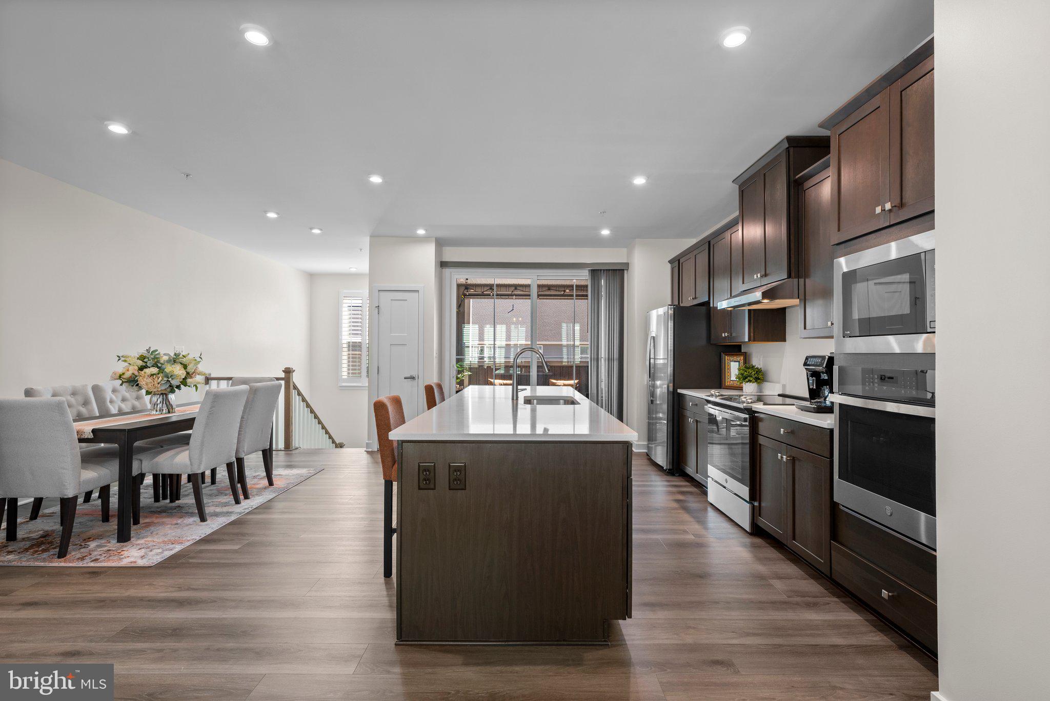 7318 Isabella Road Laurel, MD 20723 - Photo 12 of 39 a large kitchen with stainless steel appliances lots of counter space a sink and dining table