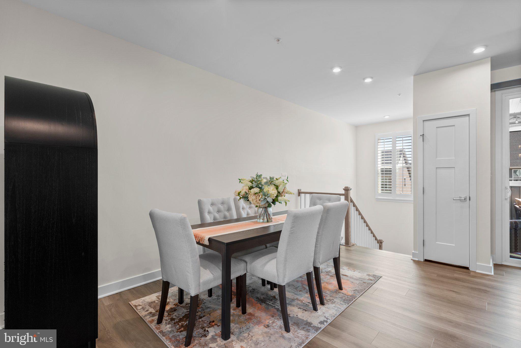 7318 Isabella Road Laurel, MD 20723 - Photo 16 of 39 a view of a dining room with furniture and wooden floor