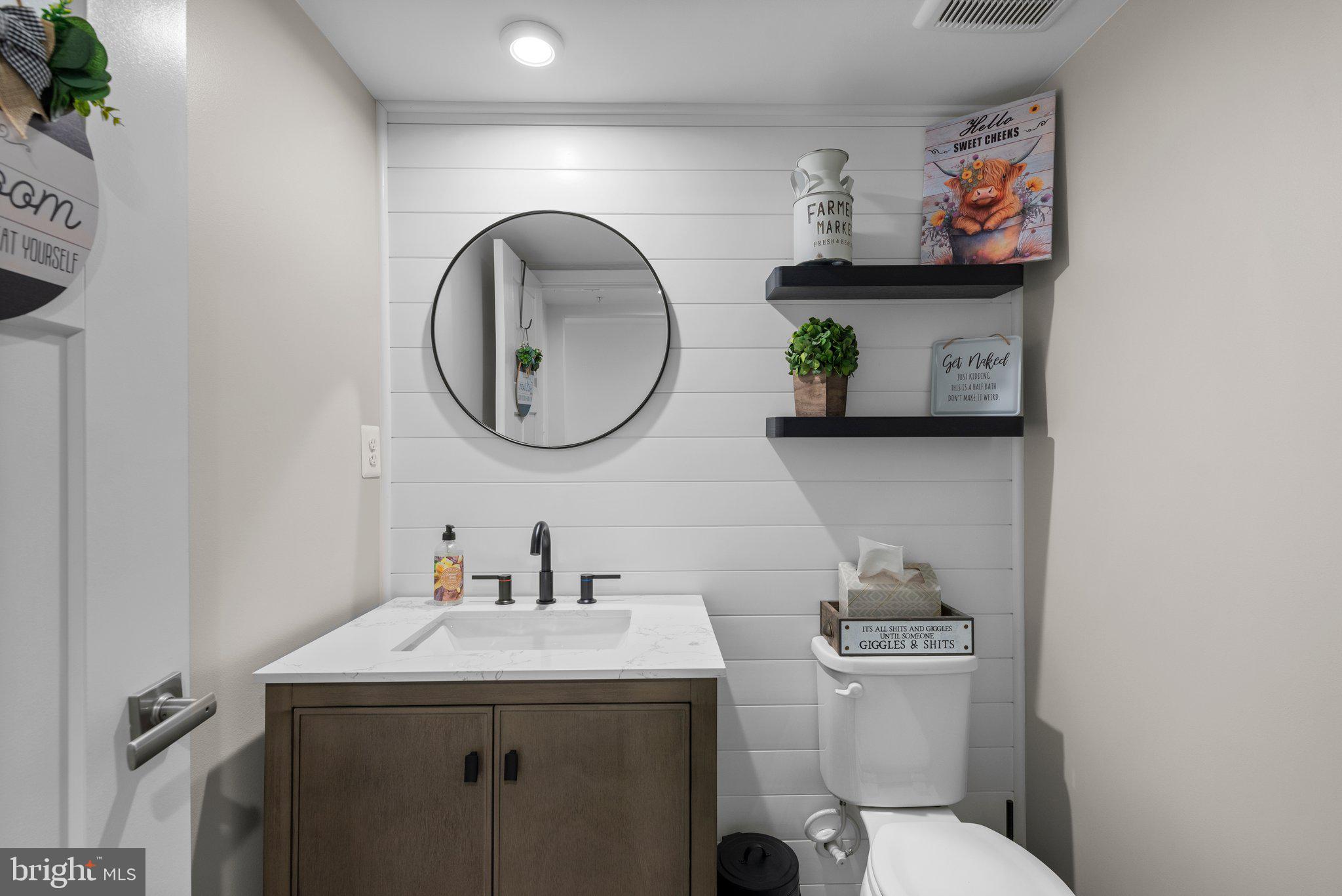 7318 Isabella Road Laurel, MD 20723 - Photo 6 of 39 a bathroom with a toilet a sink and a mirror