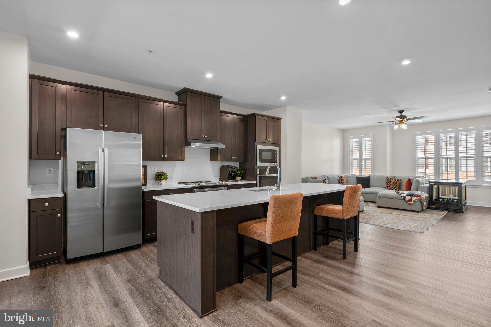 7318 Isabella Road Laurel, MD 20723 - Photo 10 of 39 a kitchen with refrigerator and chairs