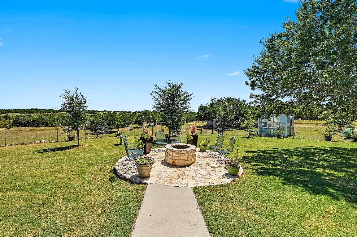 560 Saddle Ridge Drive Bertram, TX 78605 - Photo 19 of 27 a view of a backyard with sitting area