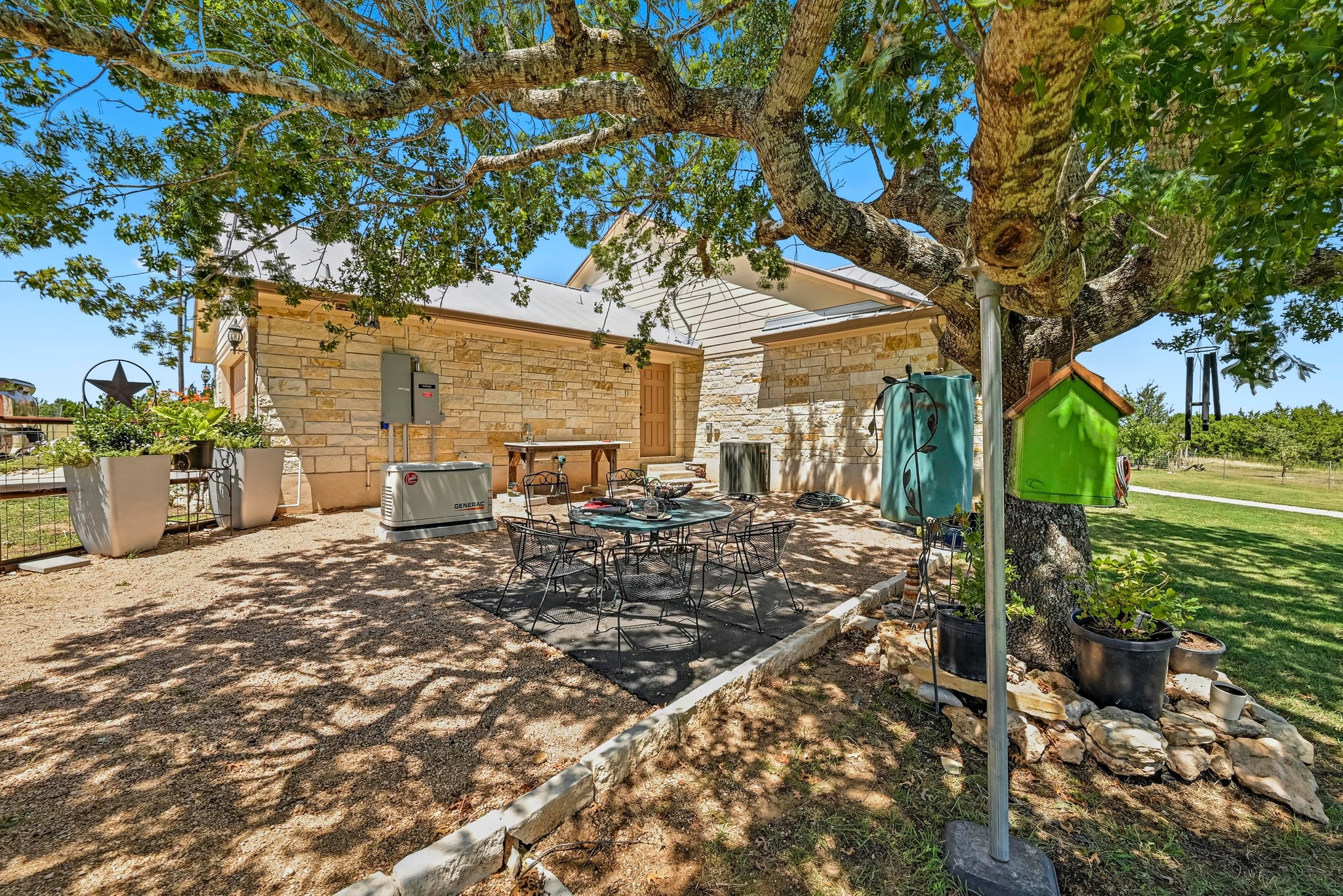 560 Saddle Ridge Drive Bertram, TX 78605 - Photo 20 of 27 a view of a yard with plants and large tree
