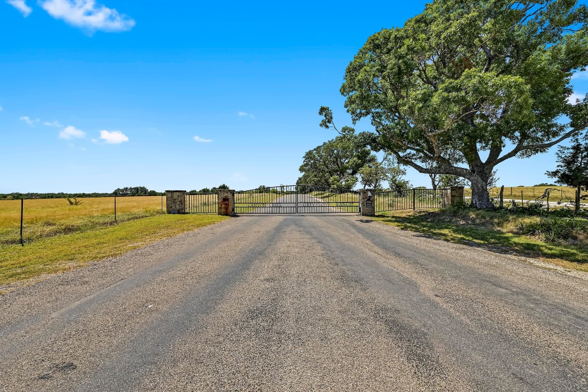 560 Saddle Ridge Drive Bertram, TX 78605 - Photo 22 of 27 a view of road with grass and trees