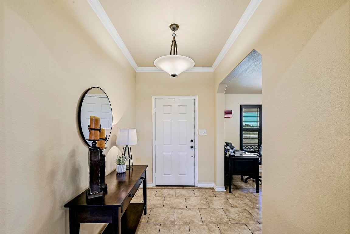560 Saddle Ridge Drive Bertram, TX 78605 - Photo 4 of 27 a view of a hallway with entryway wooden floor and a mirror