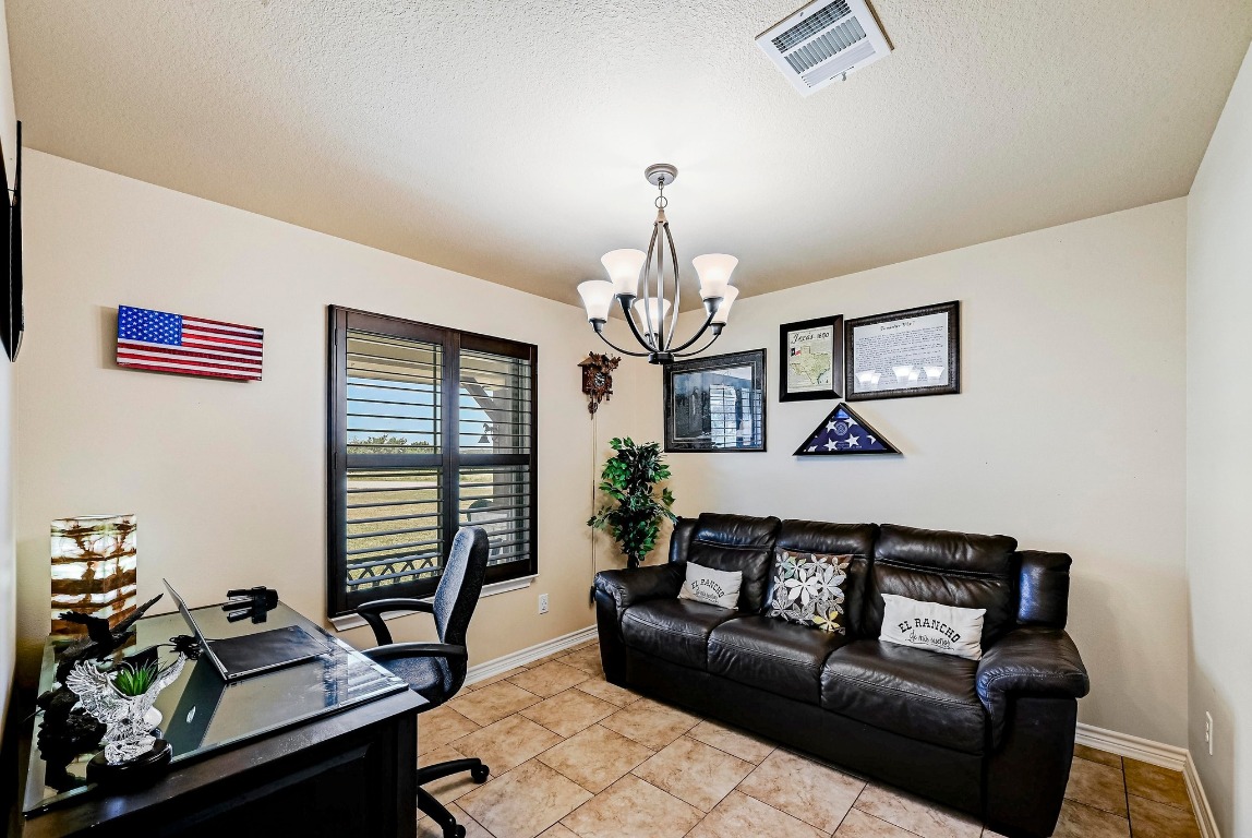 560 Saddle Ridge Drive Bertram, TX 78605 - Photo 5 of 27 a living room with furniture chandelier and a window