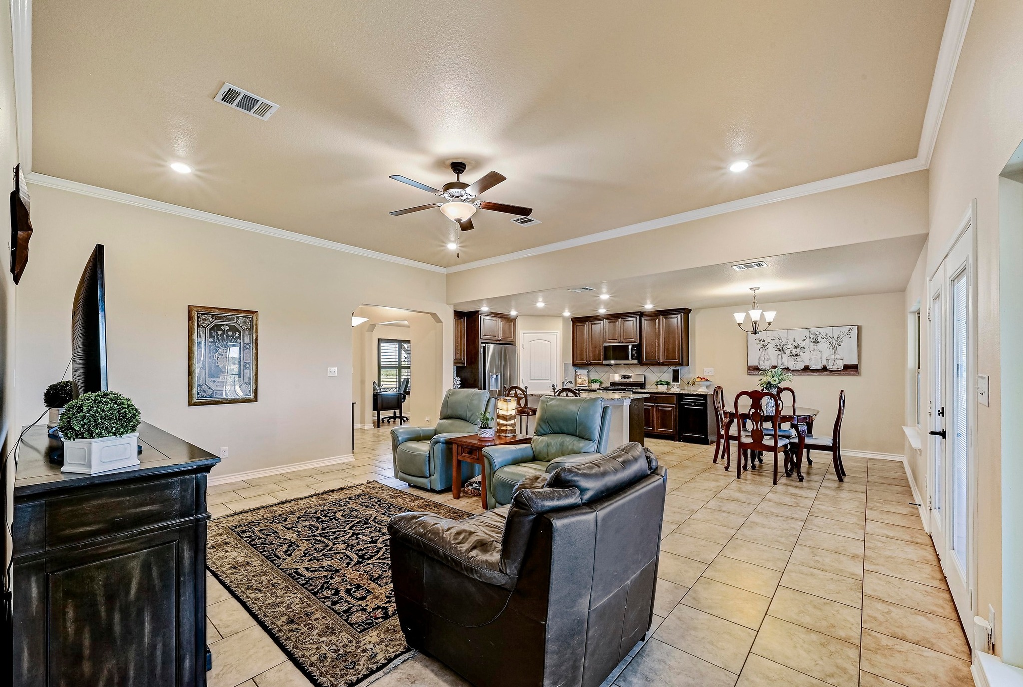 560 Saddle Ridge Drive Bertram, TX 78605 - Photo 7 of 27 a living room with furniture kitchen view and a chandelier