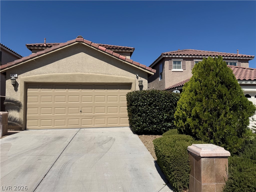 1141 Cathedral Ridge Street Henderson, NV 89052 - Photo 4 of 77 This residence features a sturdy concrete driveway leading to an attached garage.