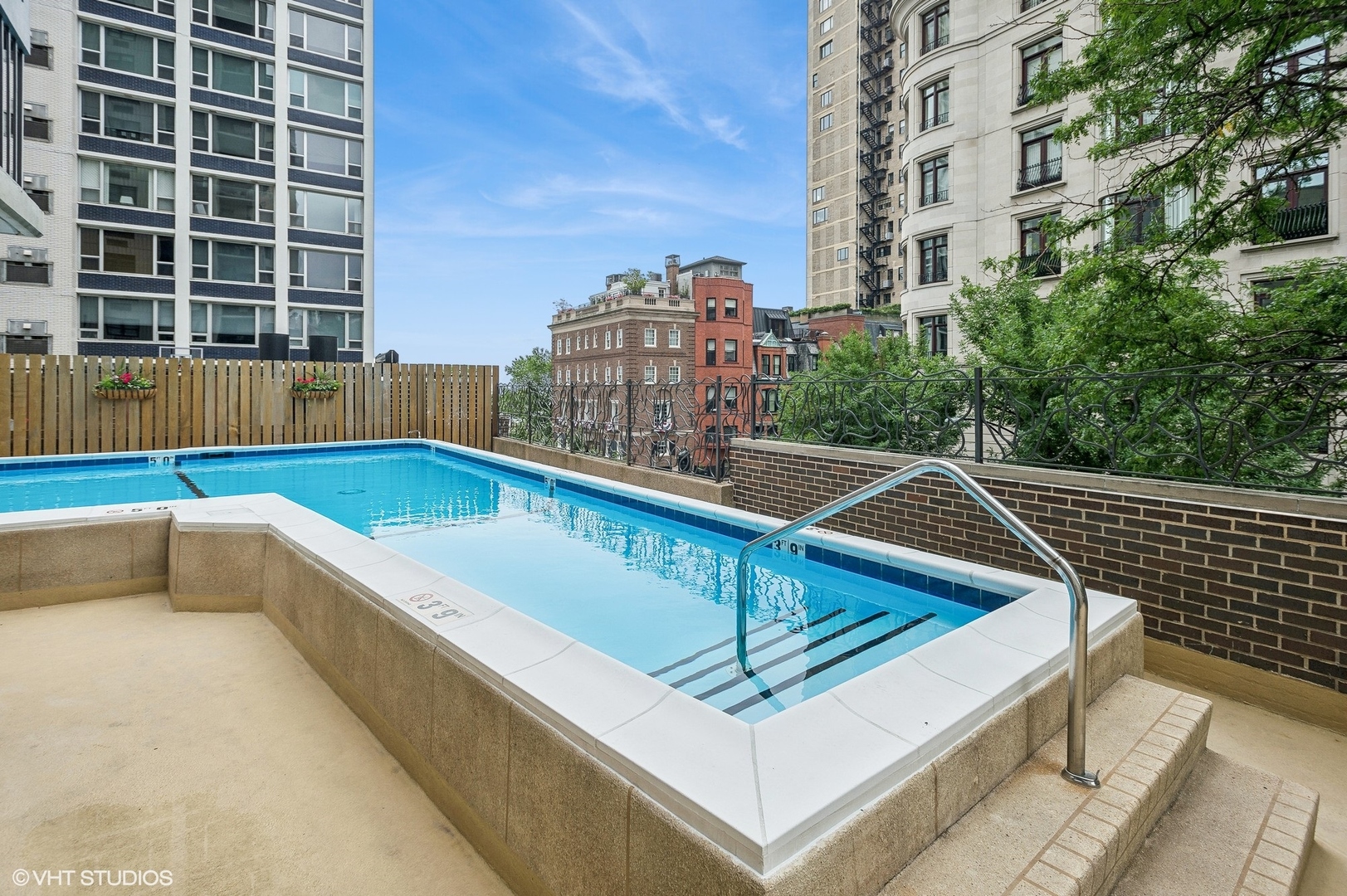 1313 North Ritchie Court, Unit 2106 Chicago, IL 60610 - Photo 7 of 12 a view of roof deck with tall buildings and a large window