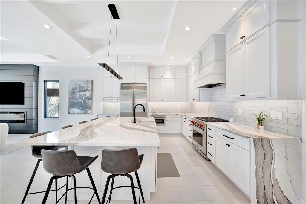 5939 Redbay Boulevard Bradenton, FL 34210 - Photo 12 of 61 a kitchen with stainless steel appliances kitchen island granite countertop a sink and cabinets