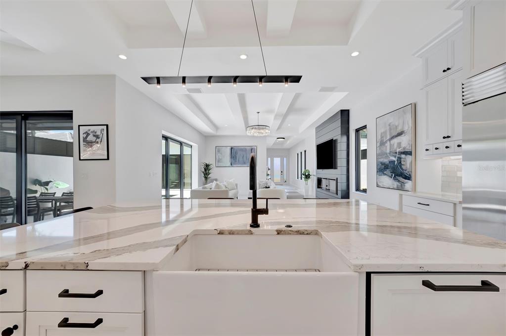 5939 Redbay Boulevard Bradenton, FL 34210 - Photo 13 of 61 a kitchen with kitchen island a sink stainless steel appliances and living room view
