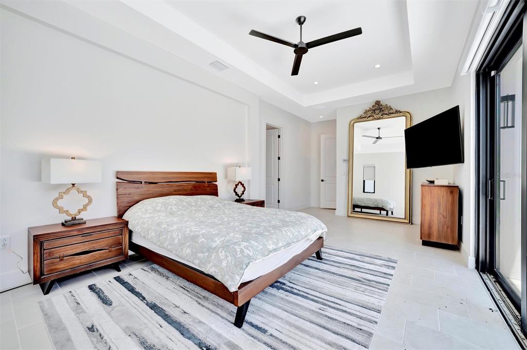 5939 Redbay Boulevard Bradenton, FL 34210 - Photo 34 of 61 a bedroom with a bed and a flat screen tv