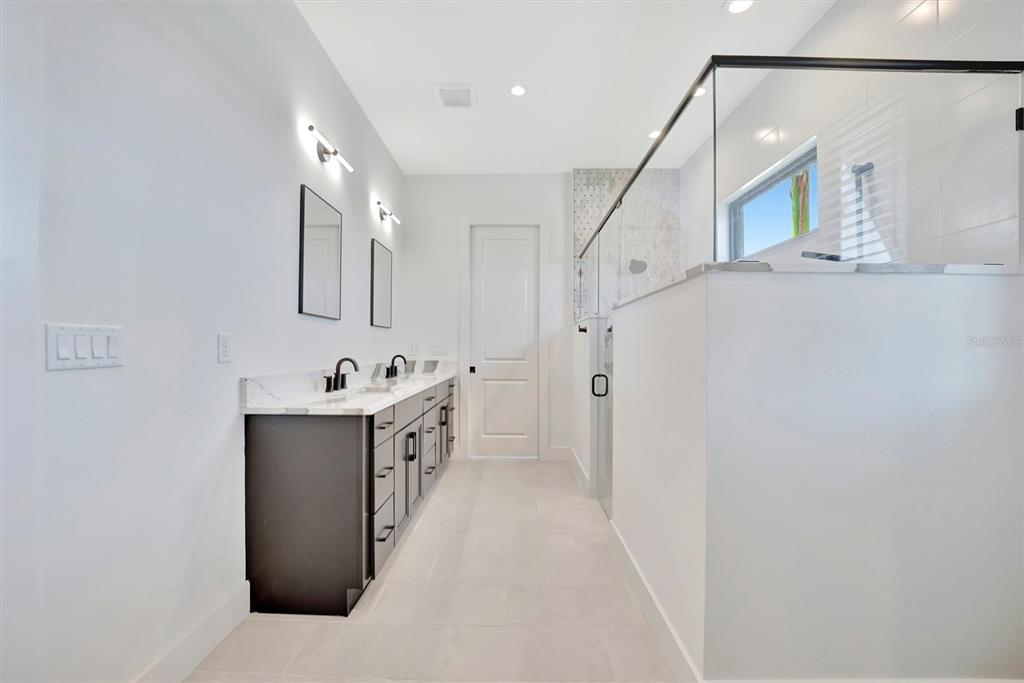 5939 Redbay Boulevard Bradenton, FL 34210 - Photo 36 of 61 a bathroom with a double vanity sink mirror and toilet