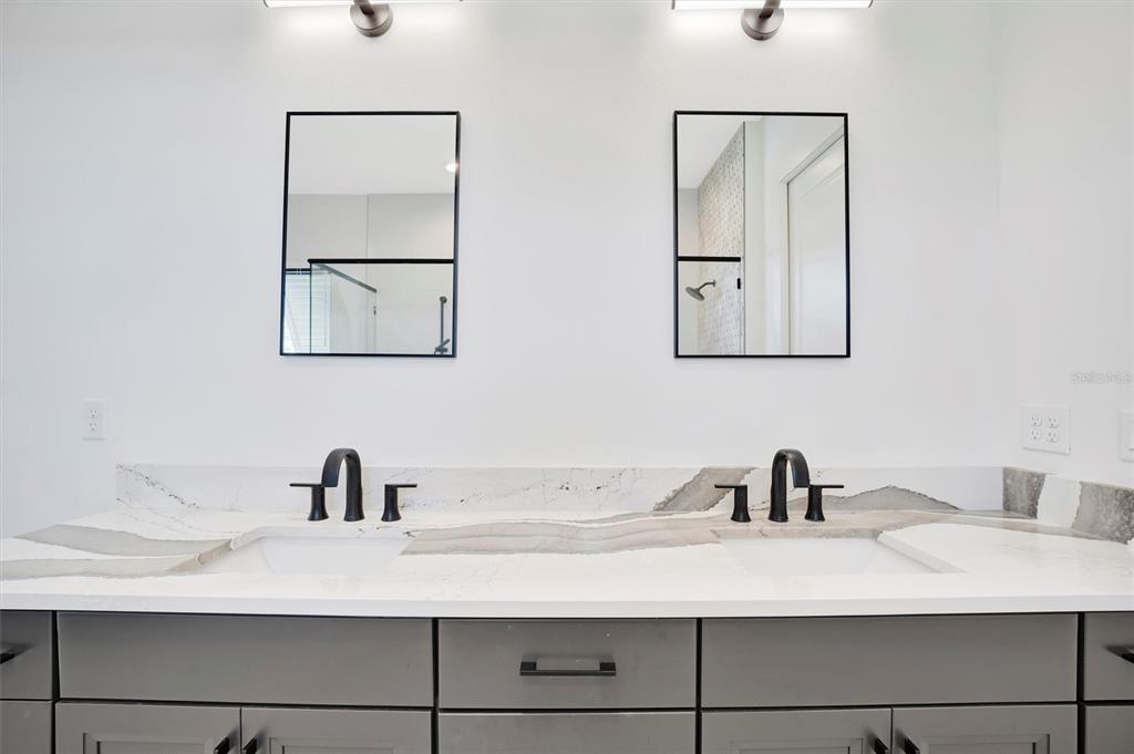 5939 Redbay Boulevard Bradenton, FL 34210 - Photo 40 of 61 a bathroom with a sink and mirror