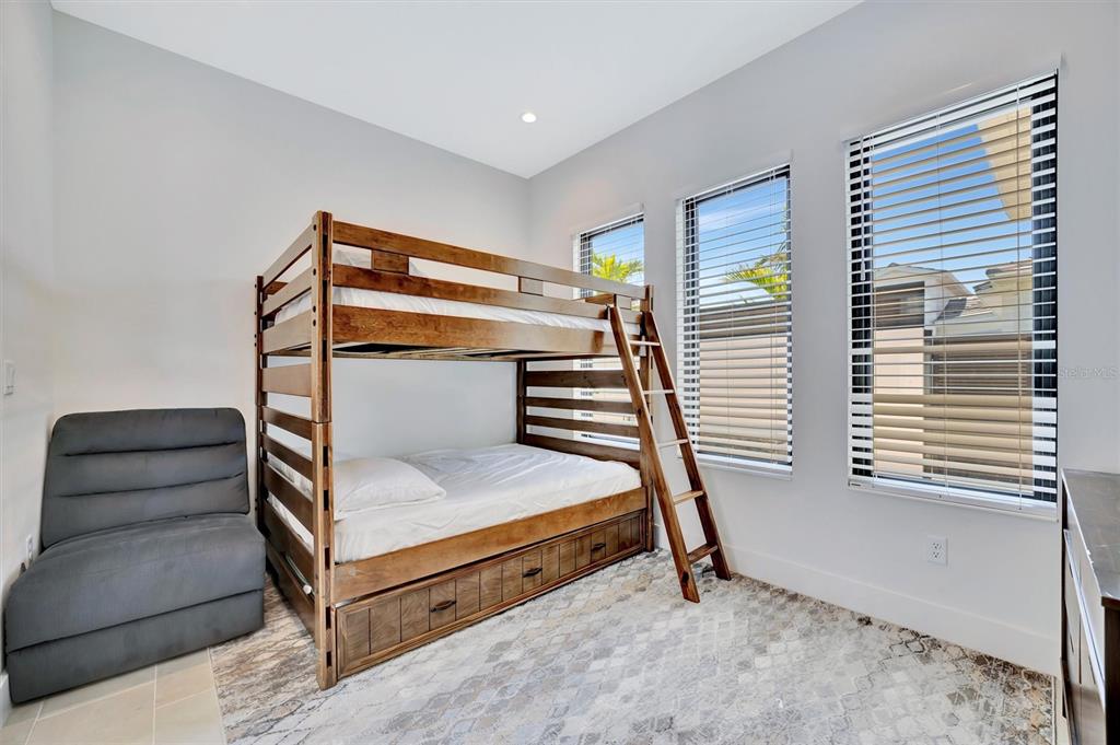 5939 Redbay Boulevard Bradenton, FL 34210 - Photo 47 of 61 a bedroom with a bunk bed and a window