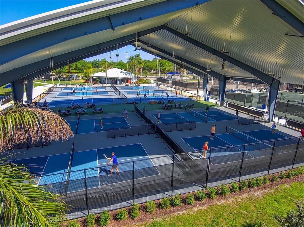 5939 Redbay Boulevard Bradenton, FL 34210 - Photo 58 of 61 a view of a patio with table and chairs