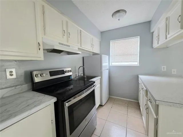 a kitchen with a stove and a refrigerator