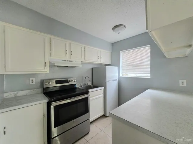 a kitchen with a stove and a microwave