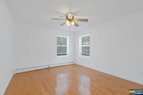 a view of a room with a window and a ceiling fan