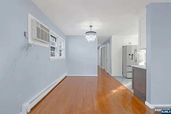 a view of livingroom with hardwood floor and a kitchen