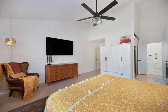 a bedroom with furniture and a flat screen tv