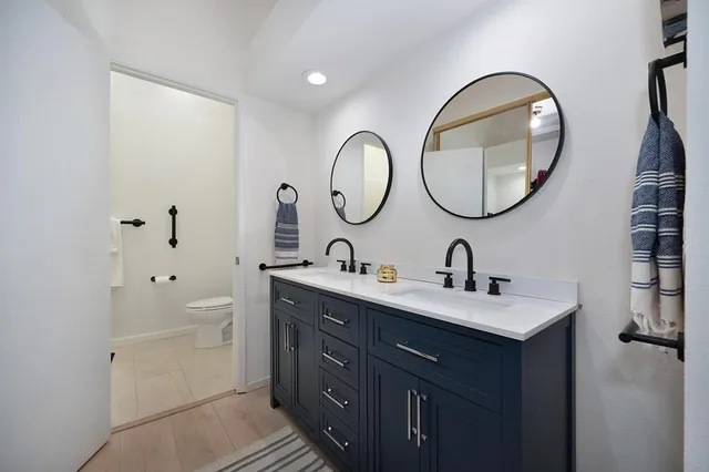a bathroom with a double vanity sink and a mirror
