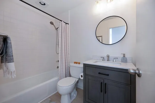 a bedroom with a bed couch and a window