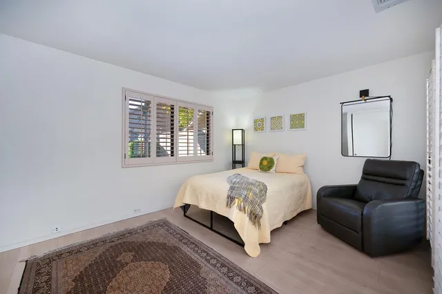 a bedroom with a bed and a television