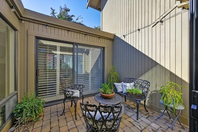 a view of a porch with furniture and garden