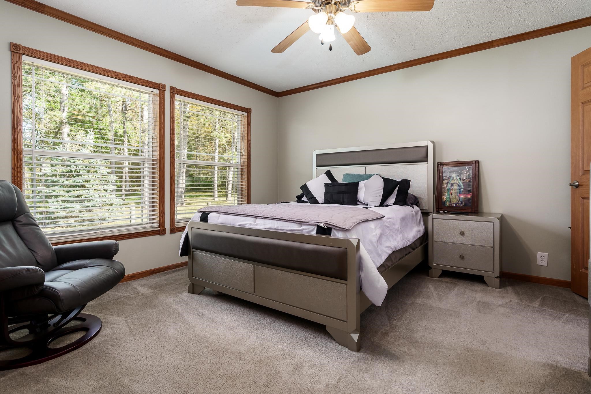 7245 South Lost Nation Road Dixon, IL 61021 - Photo 54 of 62 a spacious bedroom with a bed and a couch