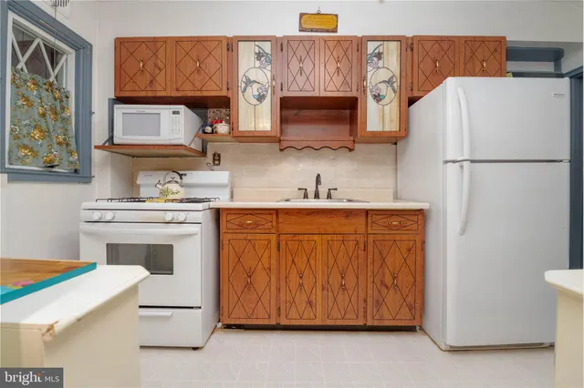 a kitchen with stainless steel appliances a stove refrigerator sink and cabinets