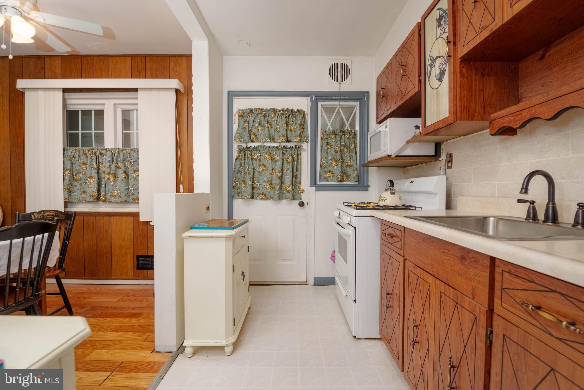 1930 Stanhope Road Baltimore, MD 21222 - Photo 12 of 32 a kitchen with a sink stove and cabinets