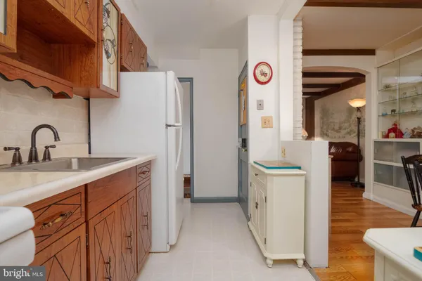 a kitchen with stainless steel appliances granite countertop a sink and a refrigerator