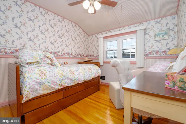 a bedroom with furniture and a large window