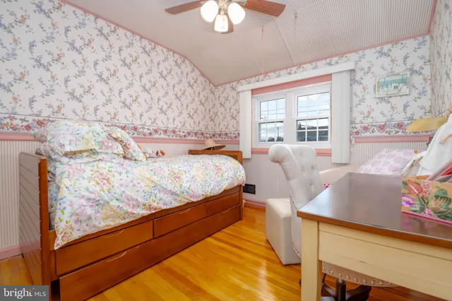 a bedroom with furniture and a large window