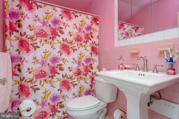 a bathroom with a sink toilet and mirror