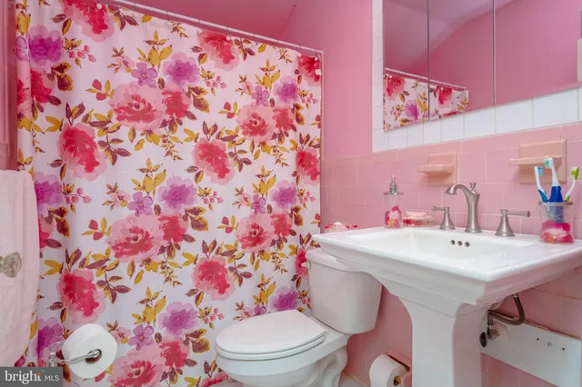 a bathroom with a sink toilet and mirror