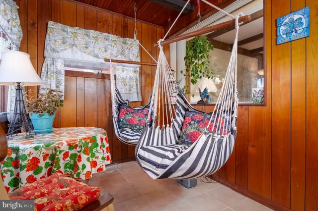 a bedroom with natural light and a bed