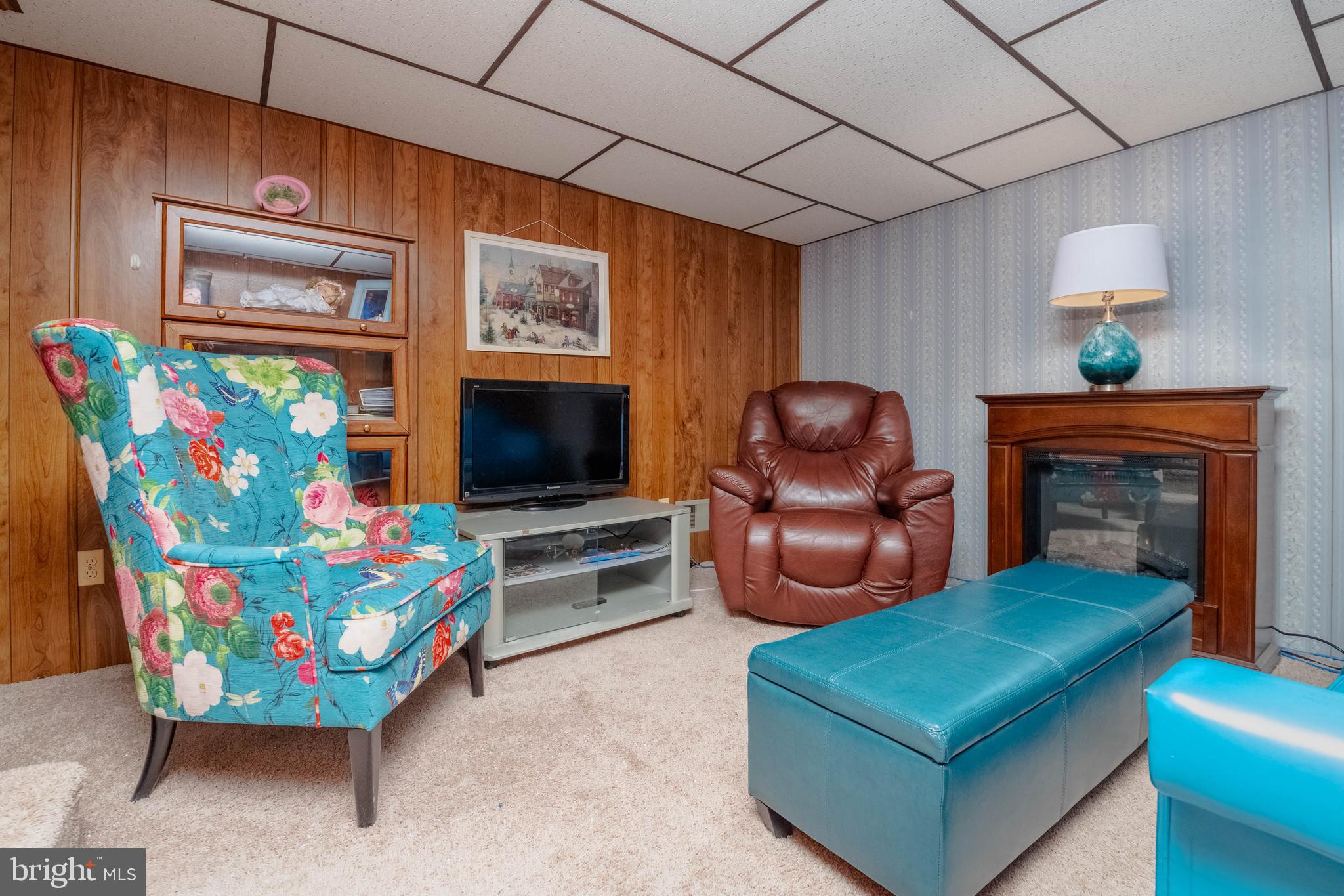 1930 Stanhope Road Baltimore, MD 21222 - Photo 21 of 32 a living room with furniture a flat screen tv and a fireplace