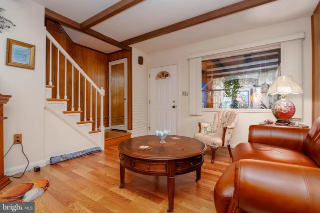 a living room with furniture a table and a potted plant