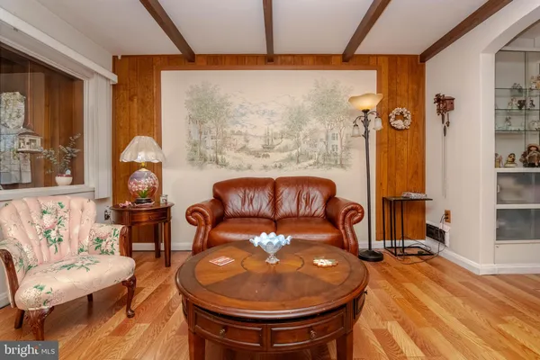 a living room with furniture a rug and a large window