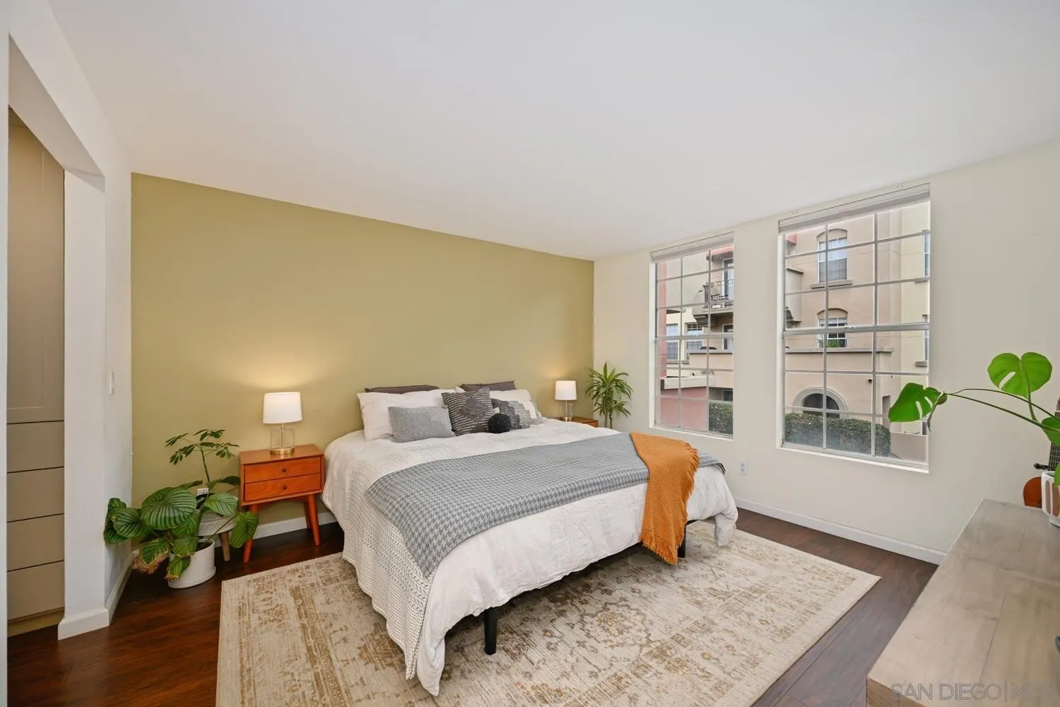 1270 Cleveland Avenue, Unit F246 San Diego, CA 92103 - Photo 11 of 23 a bedroom with a bed lamp and wooden floor