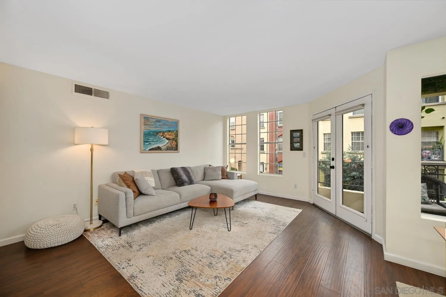 1270 Cleveland Avenue, Unit F246 San Diego, CA 92103 - Photo 2 of 23 a living room with furniture and wooden floor