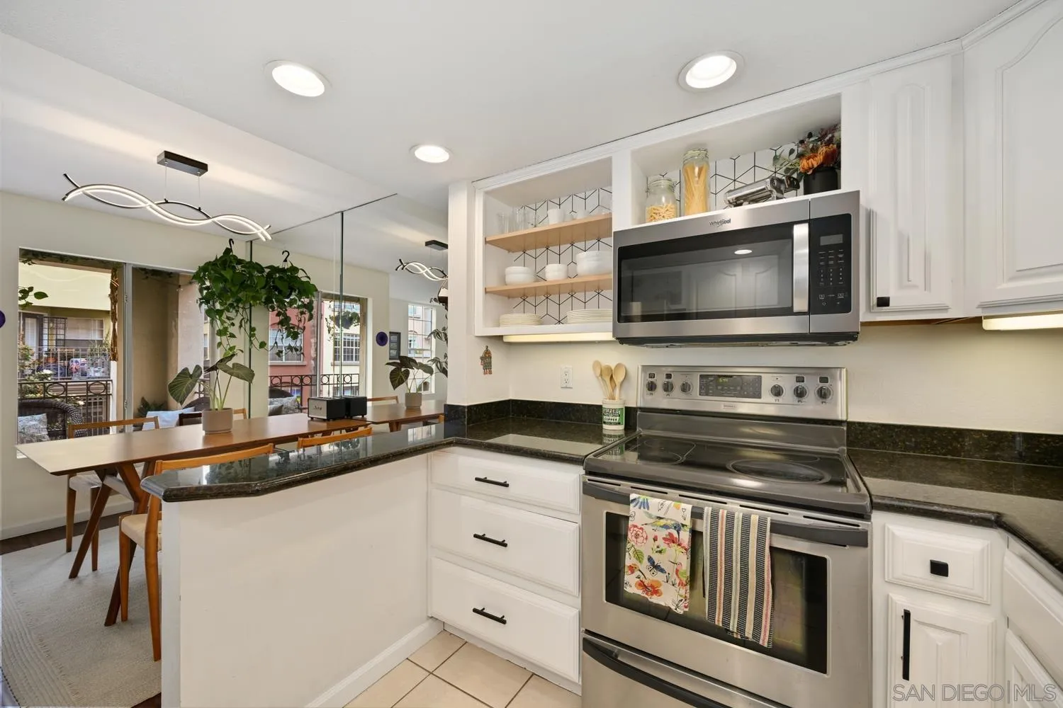 1270 Cleveland Avenue, Unit F246 San Diego, CA 92103 - Photo 7 of 23 a kitchen with stainless steel appliances a stove microwave and cabinets