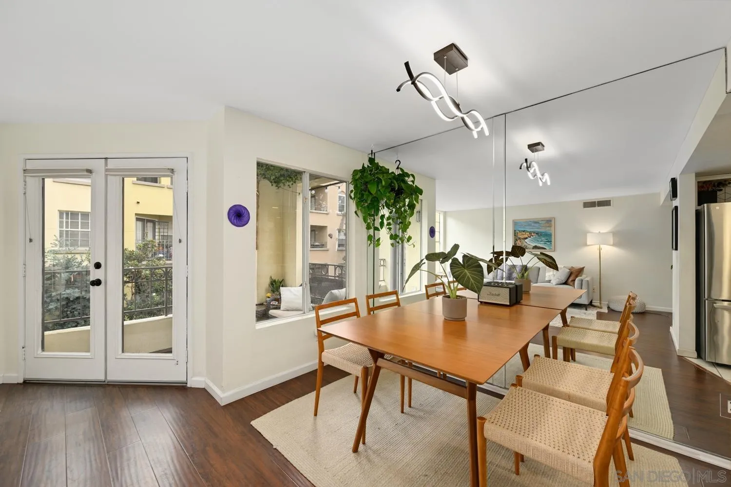 1270 Cleveland Avenue, Unit F246 San Diego, CA 92103 - Photo 10 of 23 a dining room with furniture and wooden floor