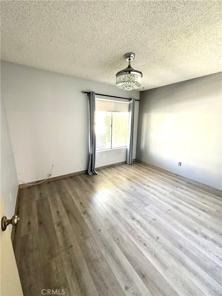 6612 Southampton Drive Cypress, CA 90630 - Photo 14 of 27 wooden floor in an empty room with a window