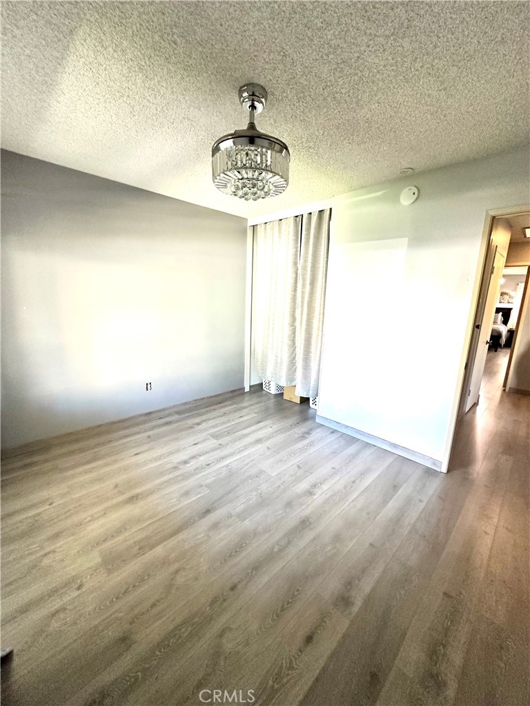 6612 Southampton Drive Cypress, CA 90630 - Photo 15 of 27 an empty room with wooden floor and windows