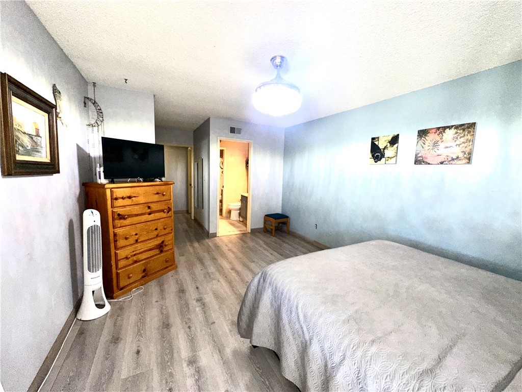 6612 Southampton Drive Cypress, CA 90630 - Photo 16 of 27 a bedroom with a bed and wooden floor
